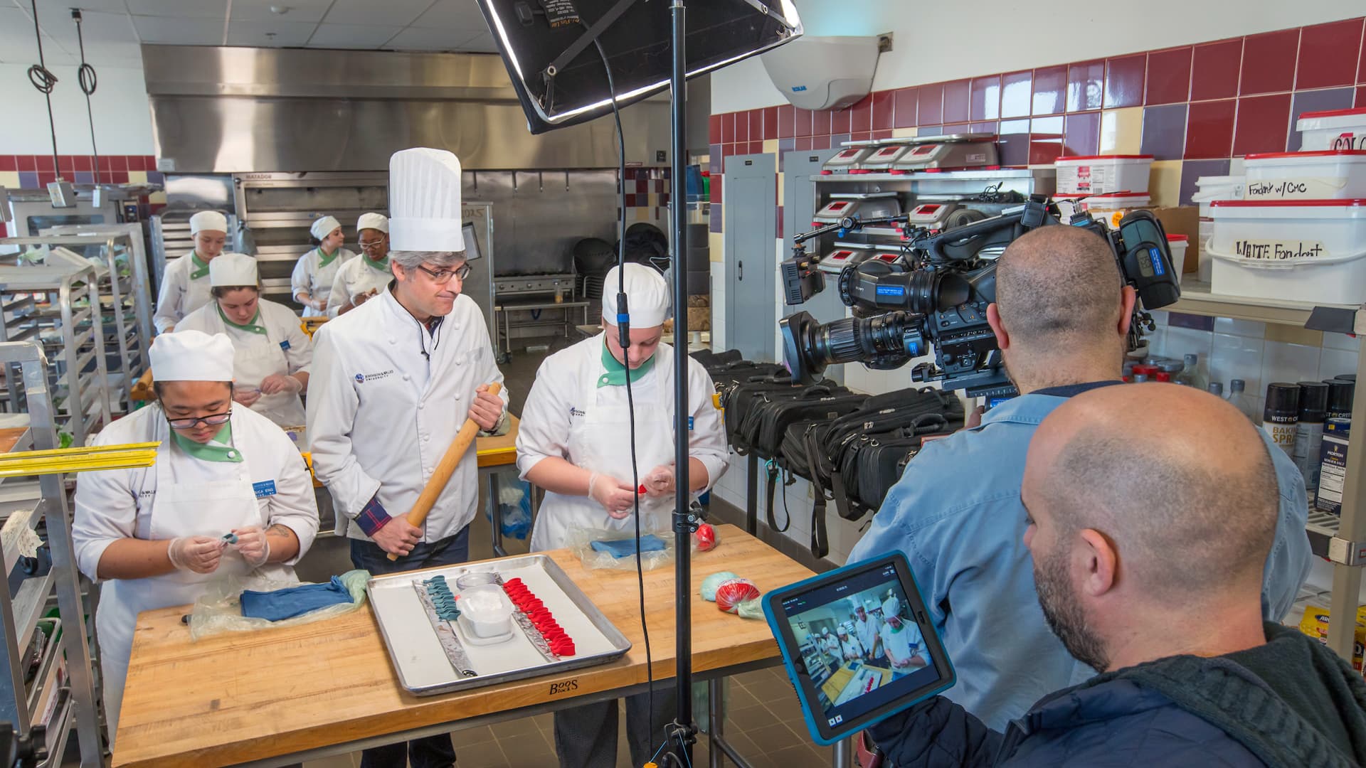And action! JWU Providence students filming a Super Bowl segment with CBS correspondent Mo Rocca