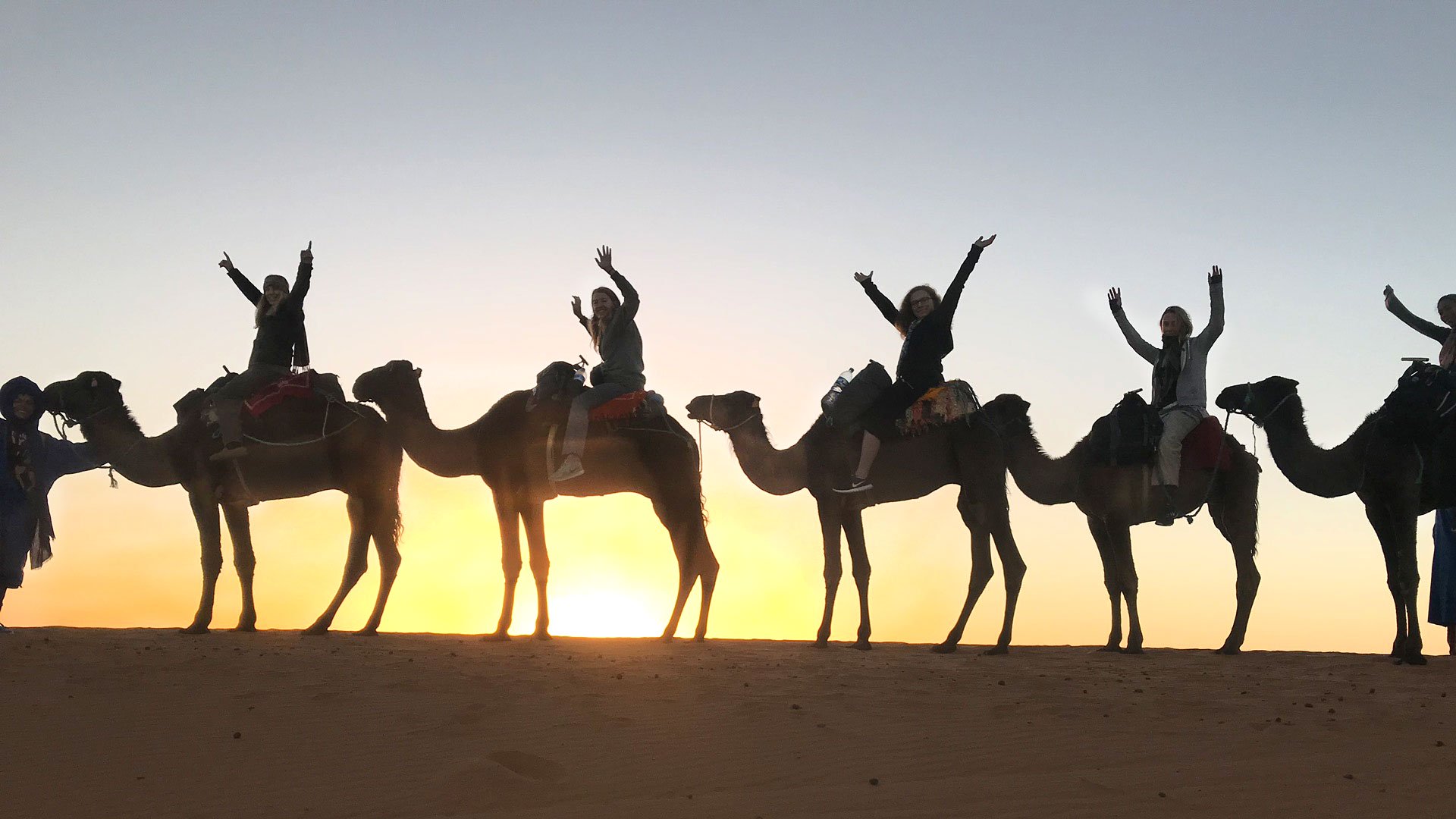 Students on camelback enjoy the Sarhara sunset