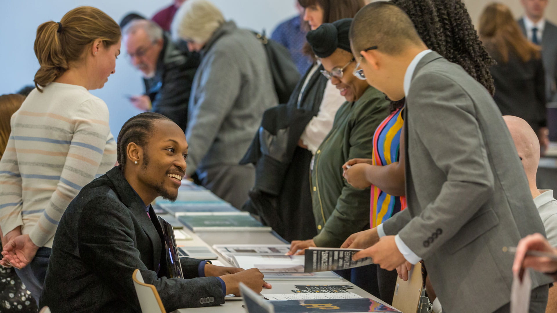 Students show their portfolios at the event.