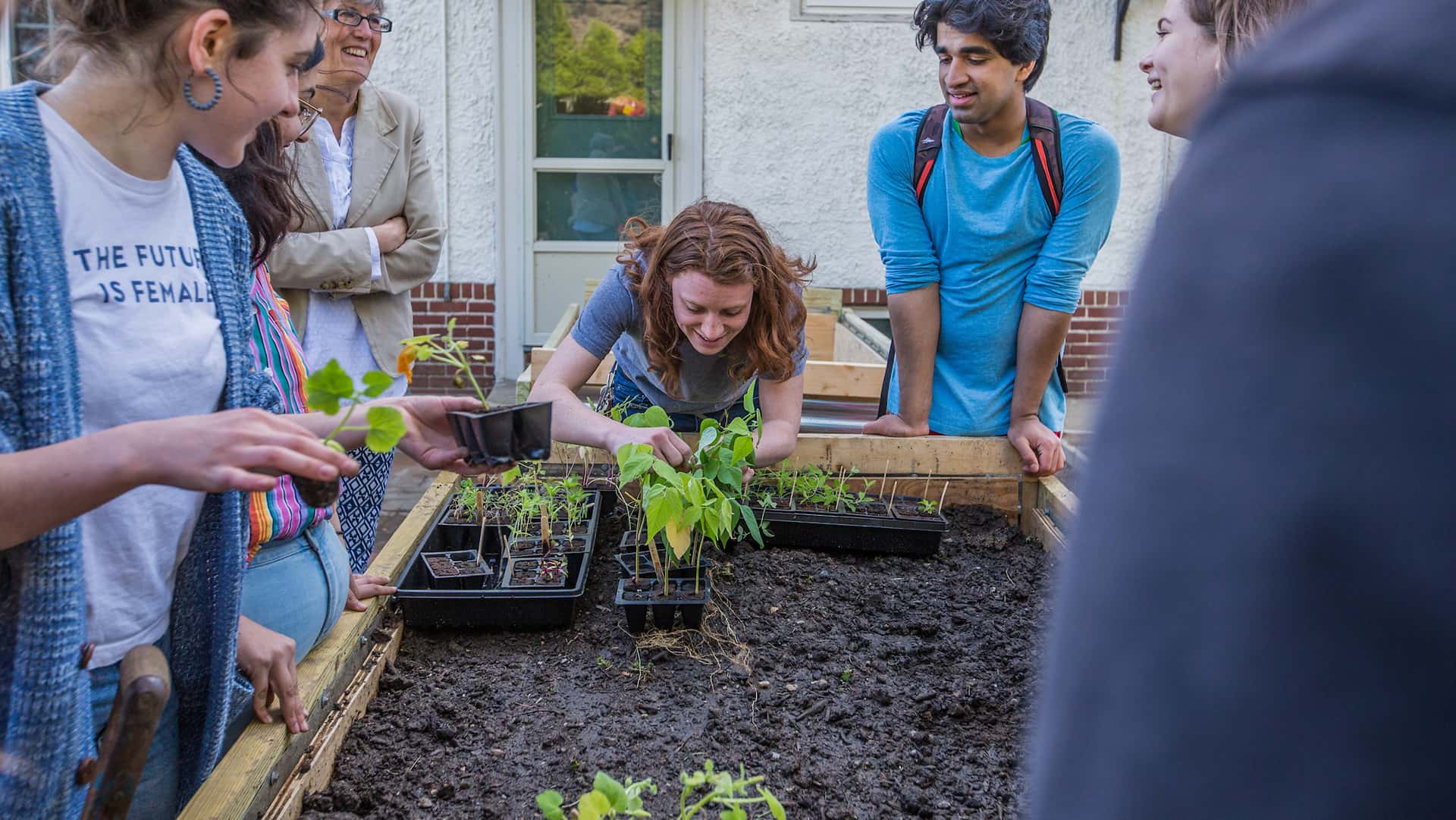 Ruth, SASS, Cooking Asia + Club of Culinary Excellence planting vegetables in the new plant beds at Harborside.