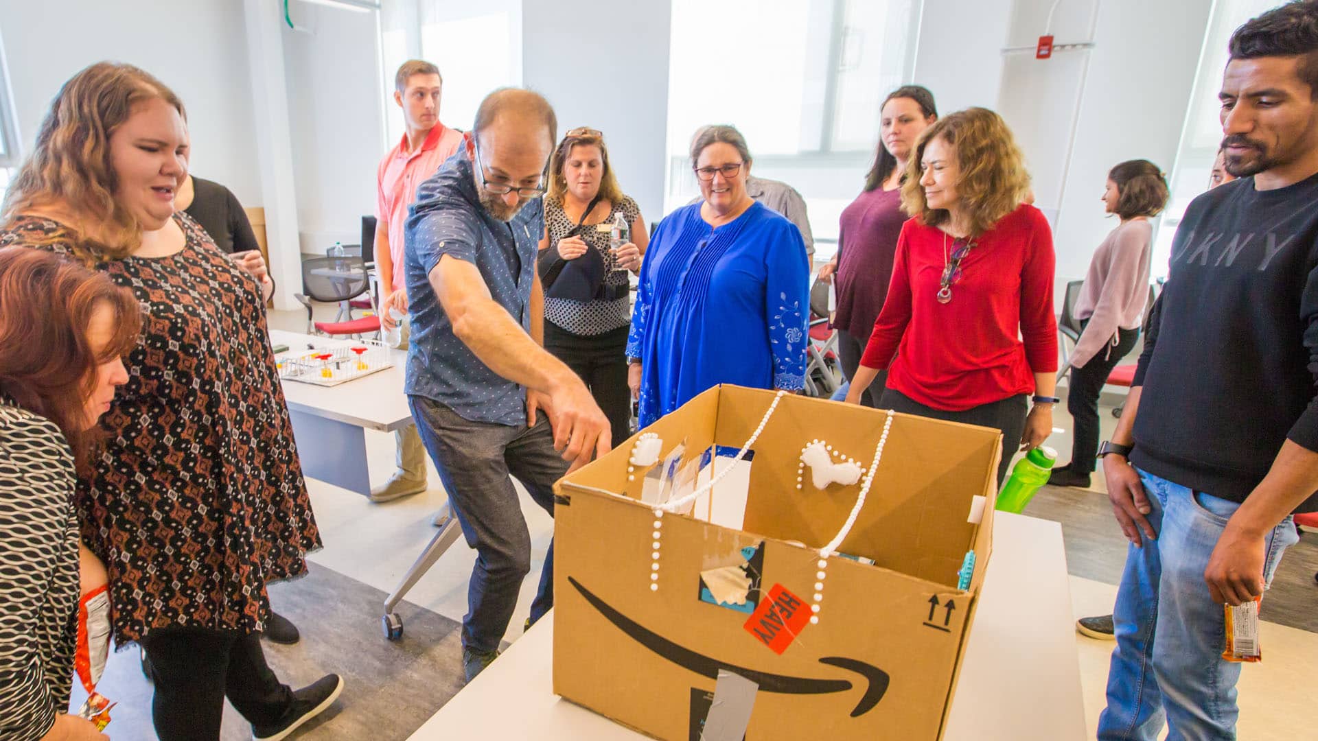 Faculty Jonathan Harris and Amy Wagenfeld look over one of the coffee shop concepts.