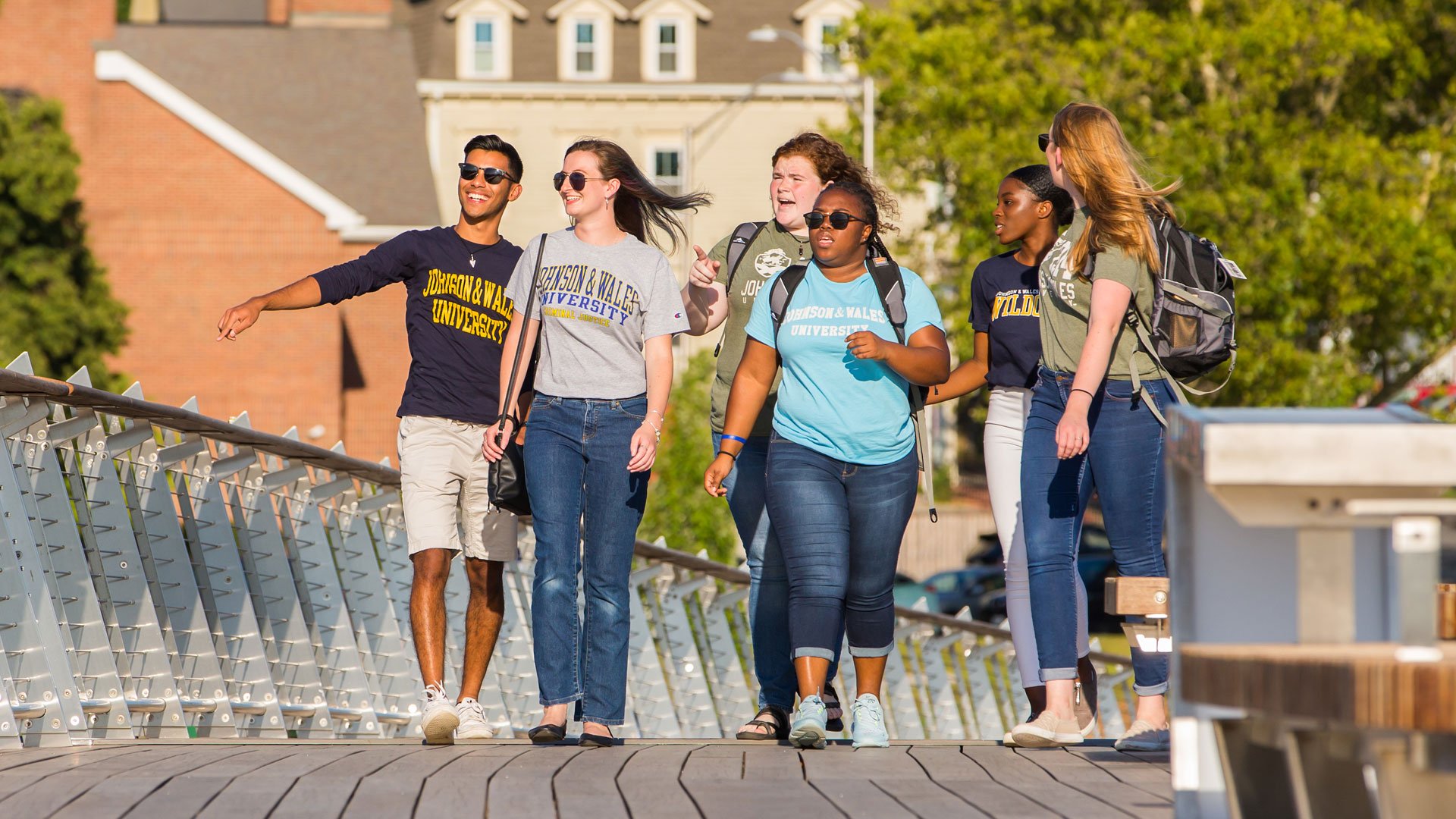 JWU students walking across the new Pedestrian Bridge