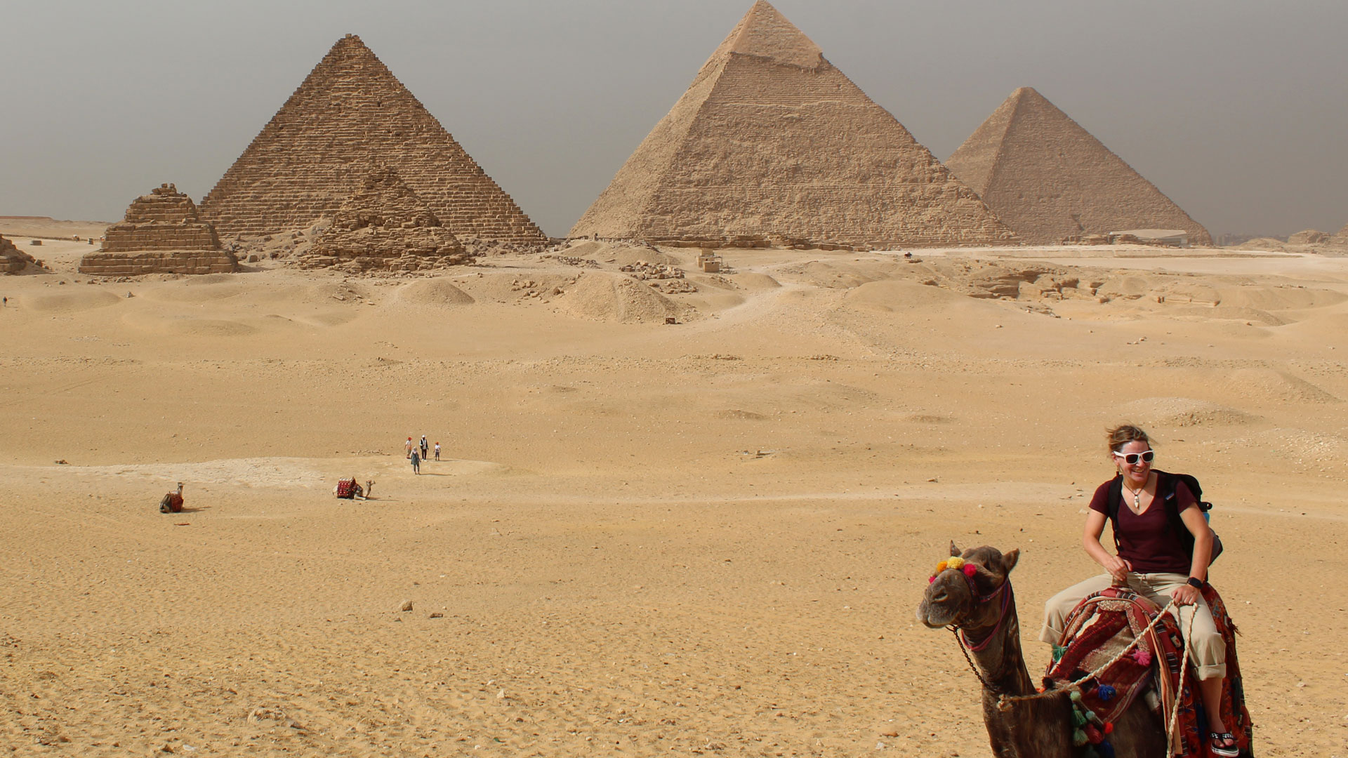 In front of pyramids.