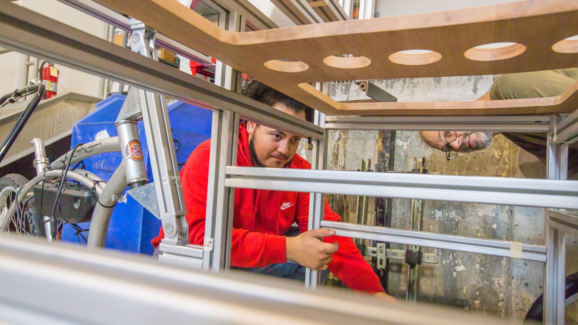 Sebastian Silva ’20 works on building the bike food-cart with Associate Professor Jonathan Harris.