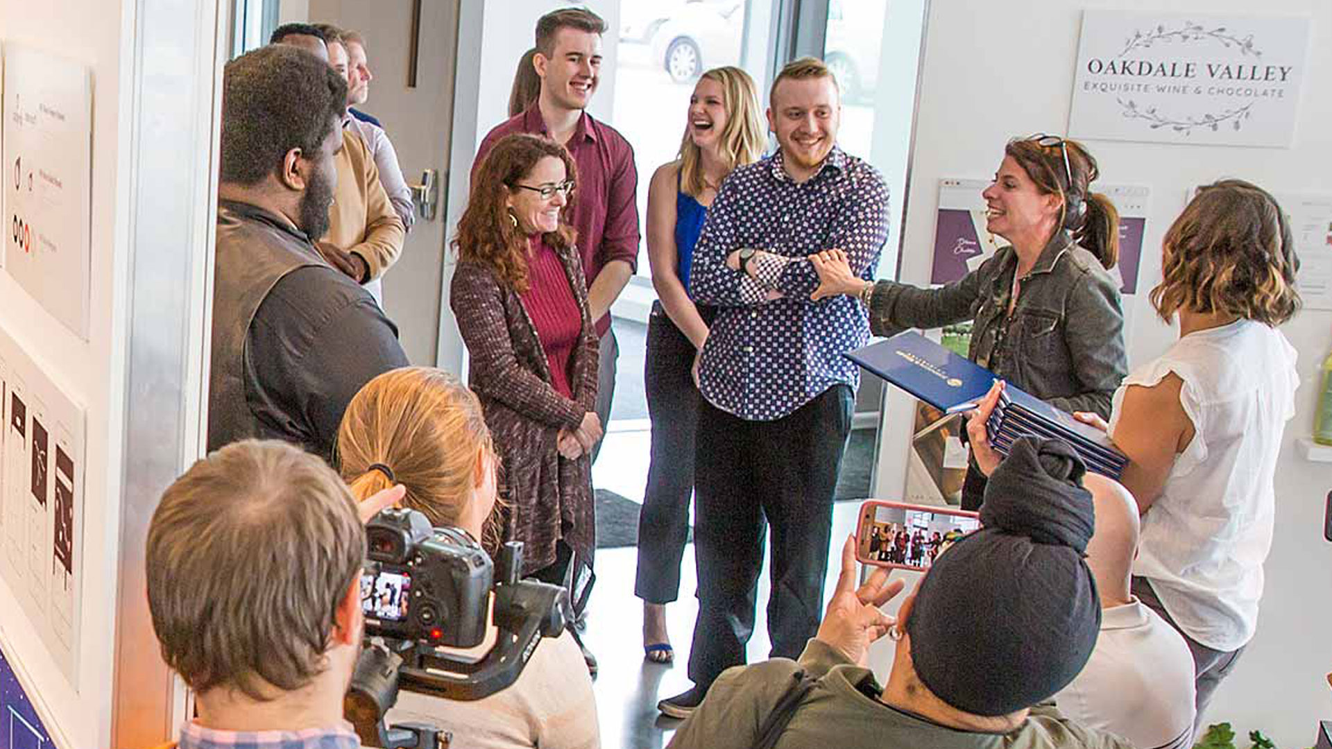 Asso. Professor Deana Marzocchi with students at annual REVEAL show of senior portfolios and exhibits