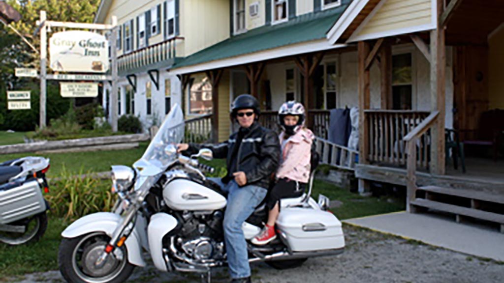 A man and girl on a motorcycle