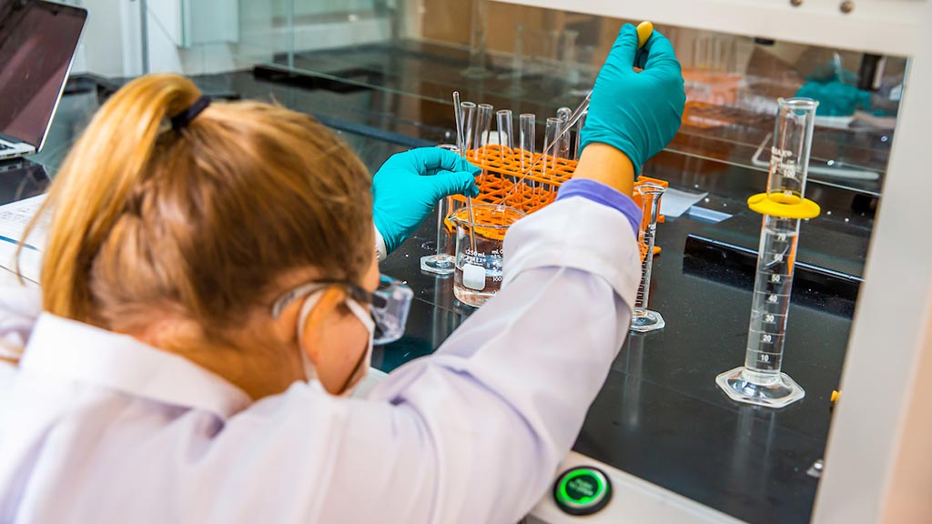 chemistry student with test tubes