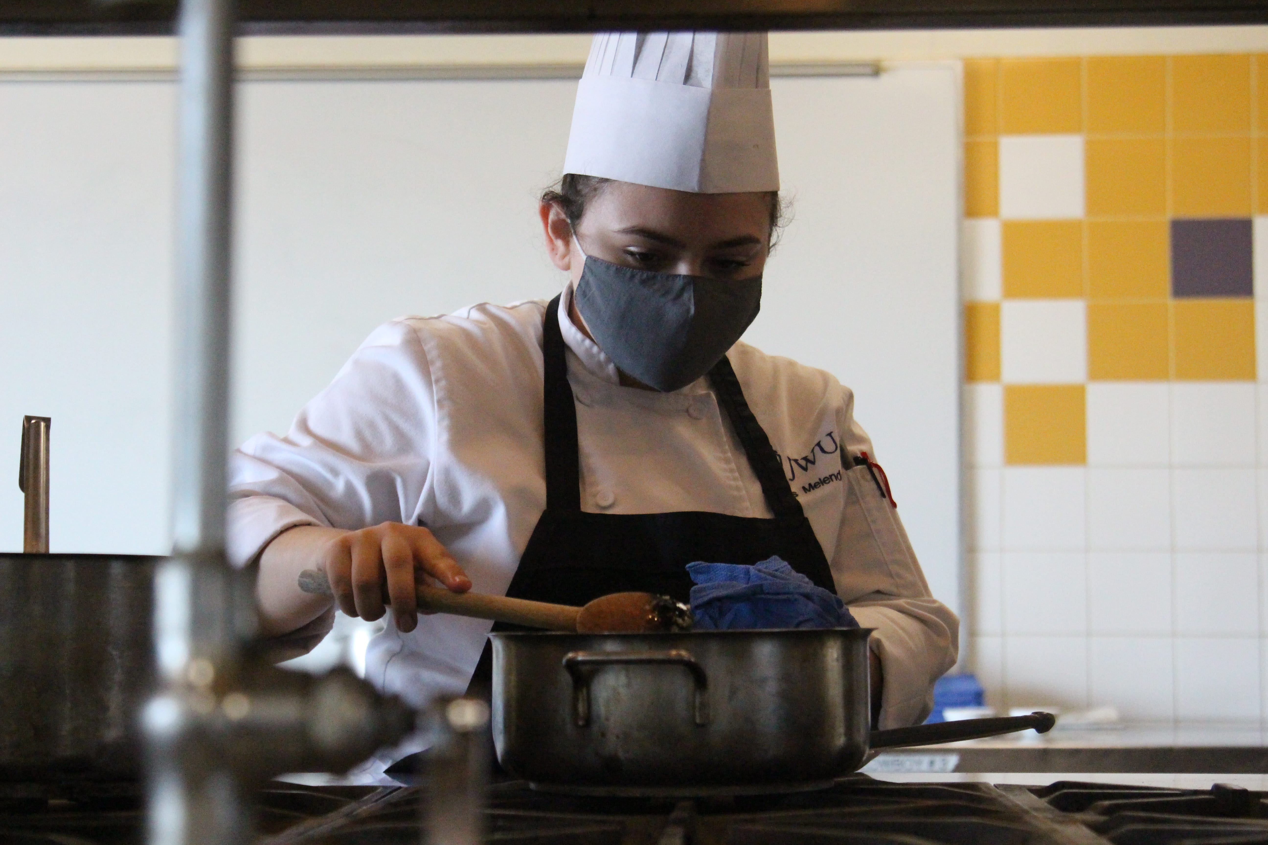 Student Annalis Melendez stirs risotto