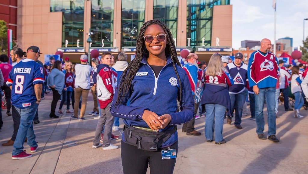 student on internship in front of stadium