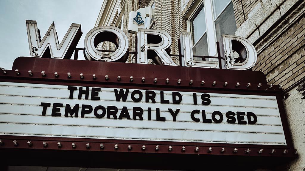 A marquee sign that reads "The world is temporarily closed."
