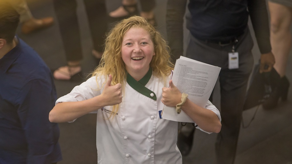 Student with thumbs up at career fair