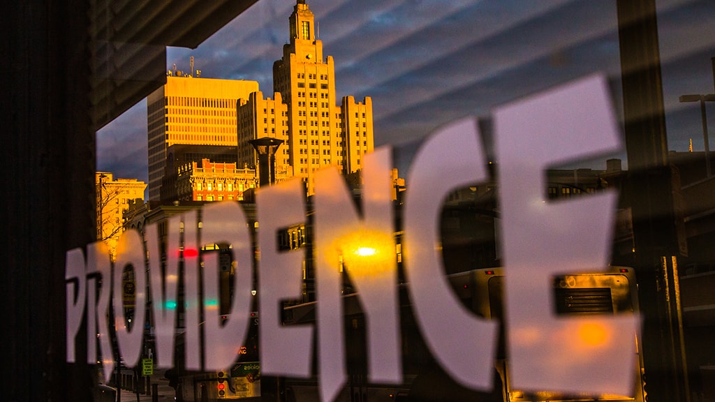 Reflection of the word "Providence" and skyline in downtown window