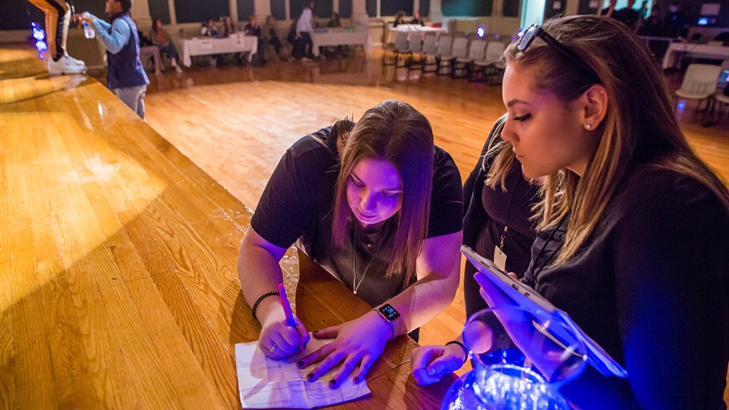 Students prepping for a concert that they're in charge of putting on 