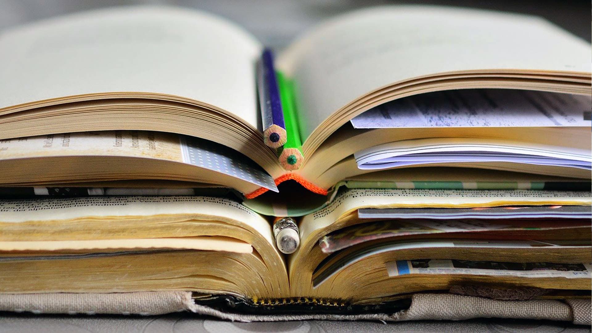 JWU’s 12th Annual Academic Symposium recently highlighted excellence in academic work. Visual: Stack of research books.