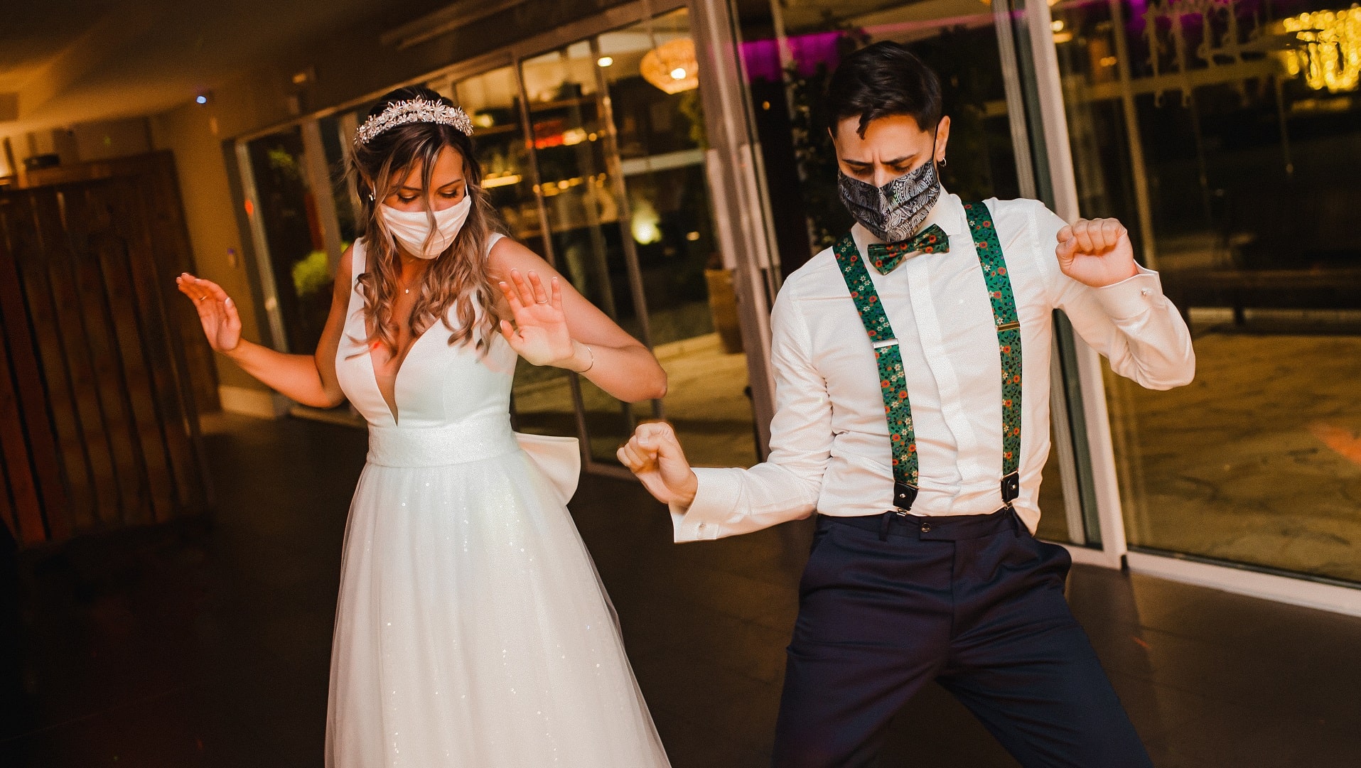 wedding couple dances together wearing masks