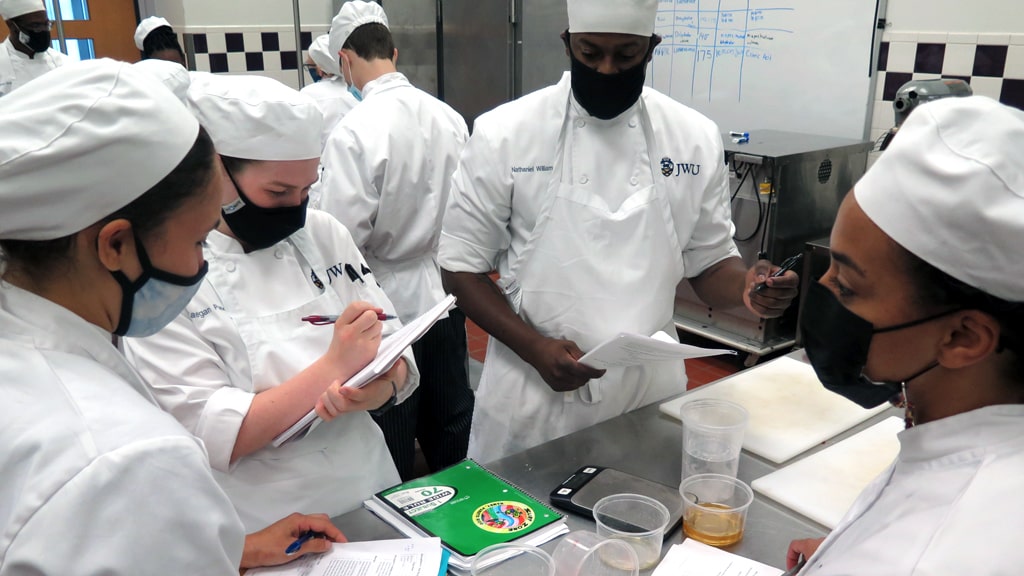 Nate Williams (center) works on a culinary nutrition group project at JWU Charlotte.