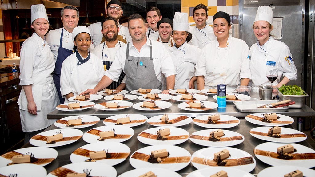 Robert Sisca '03 and JWU students with the food they prepared together