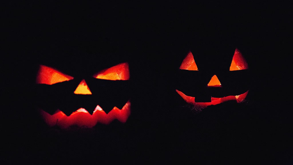 carved pumpkins at night