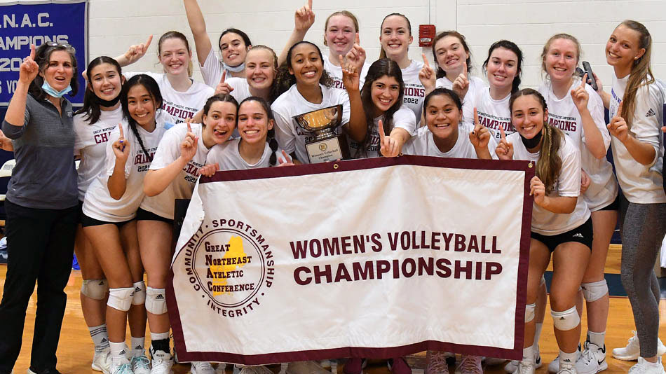 The JWU Women's Volleyball team proudly holds up their GNAC 2021 Champions banner