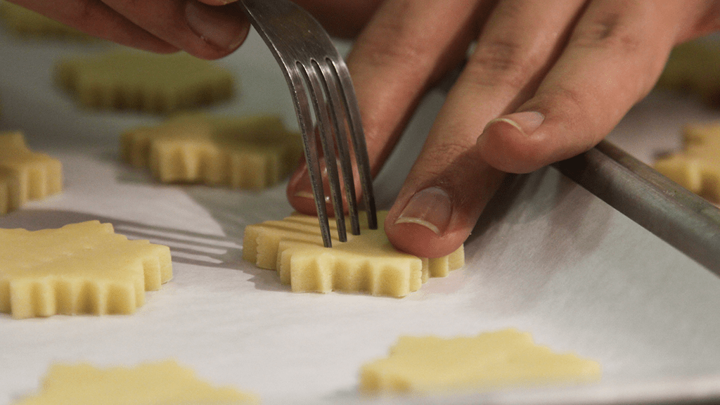 closeup of a fork poking into the cookie shapes