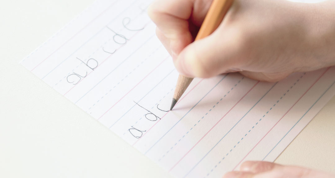 decorative closeup photo of someone trying to write the alphabet in order