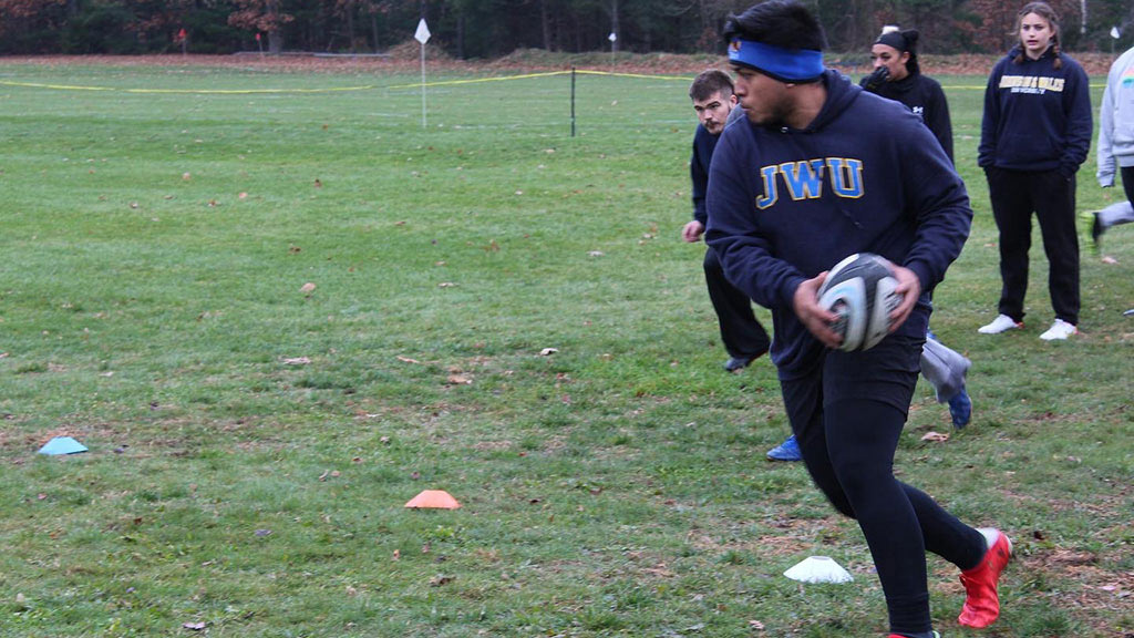 action shot of Xavier Quinata playing rugby at JWU