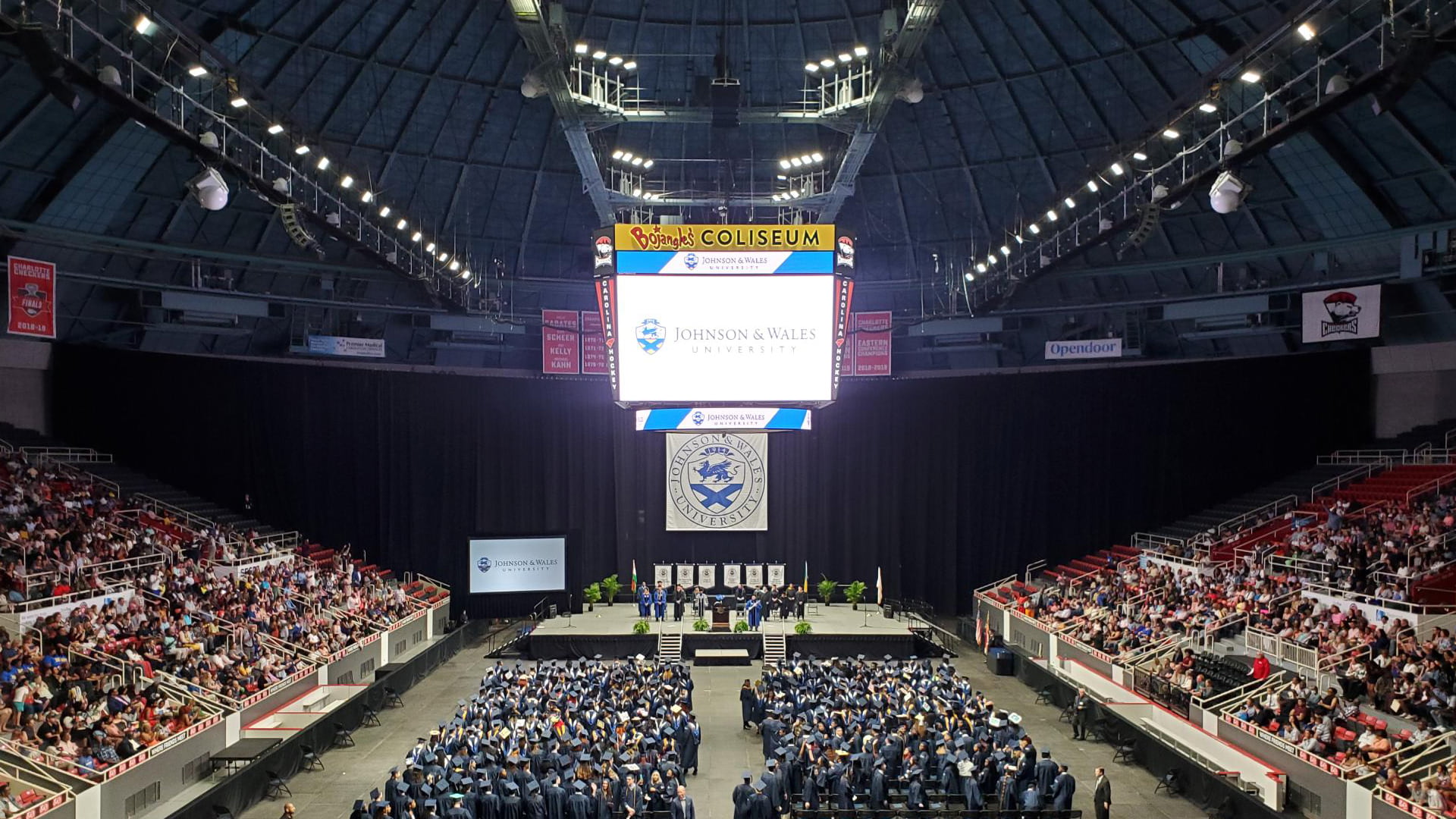 Students taking their seats at Charlotte Commencement.