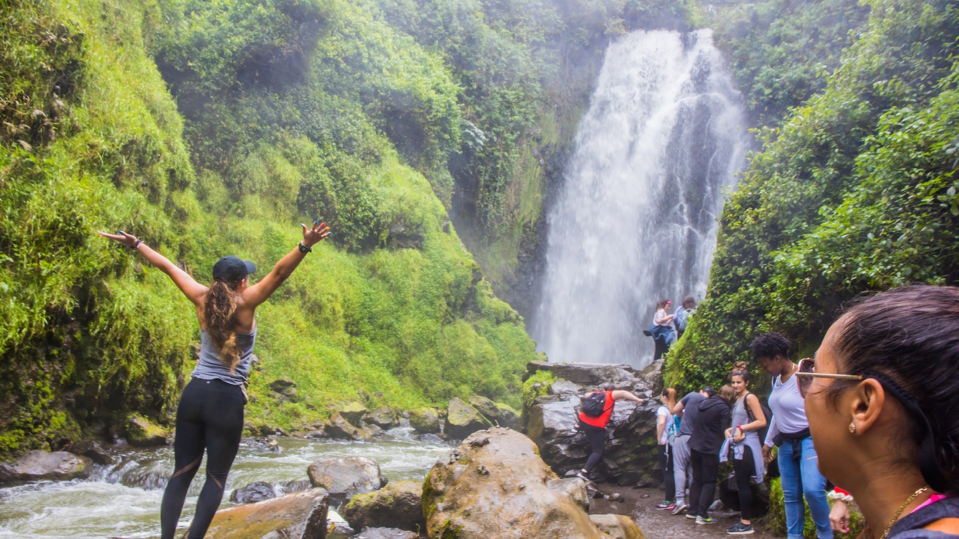 a group of students watching a waterfall