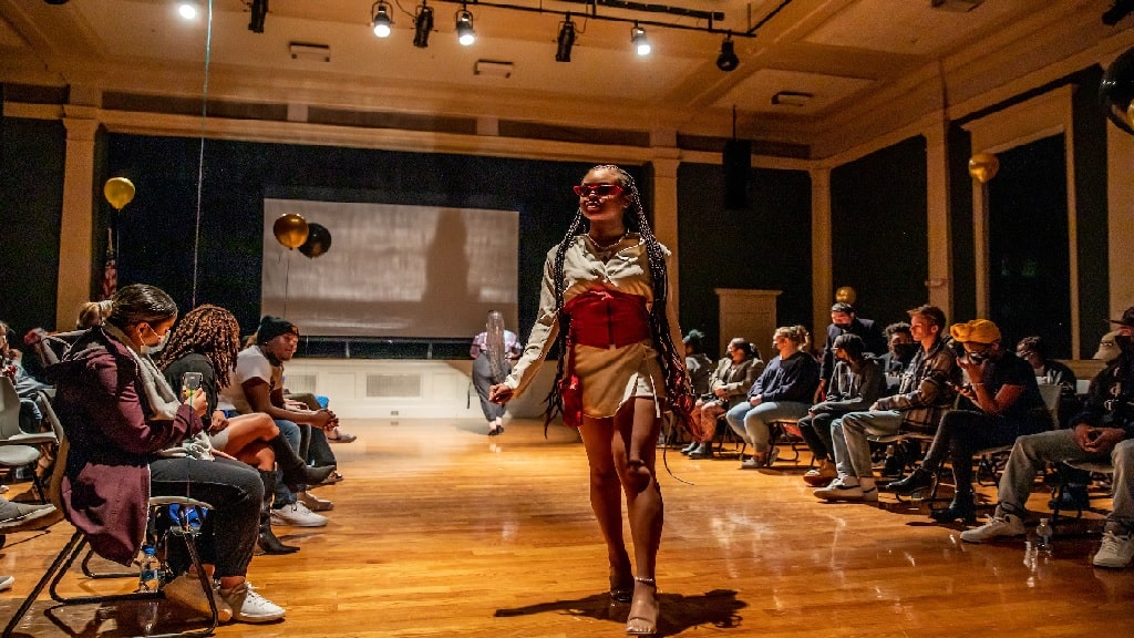 a girl walking in a fashion show