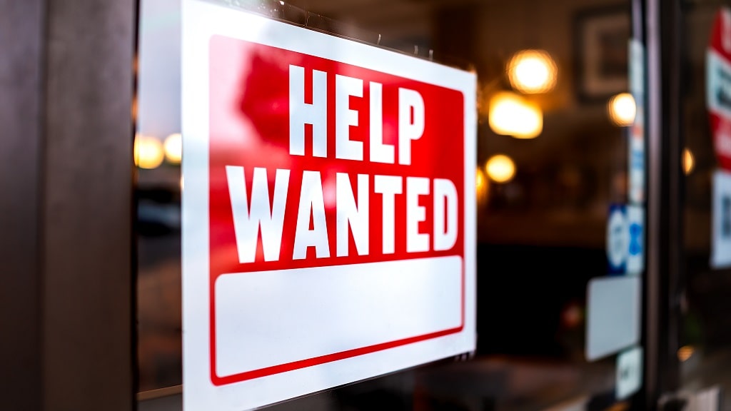 Help wanted sign posted on window of business