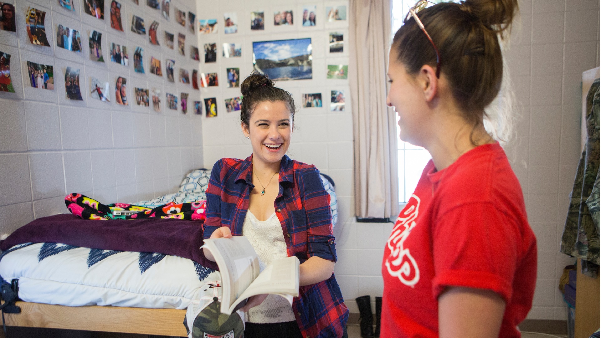 two girl roommates laughing in their dorm