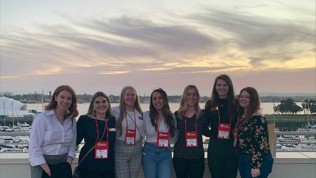 Madison Allan '23, center, poses with other students at a recent CCMA Conference