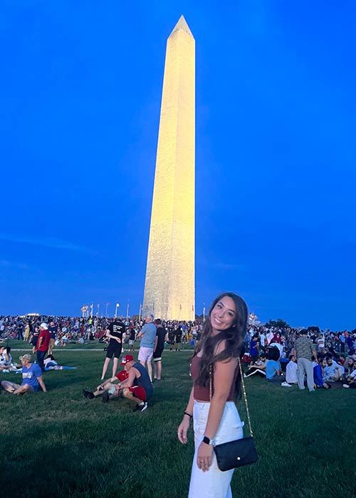 Madison Allan '23 poses smiling in front of the Washington Monument