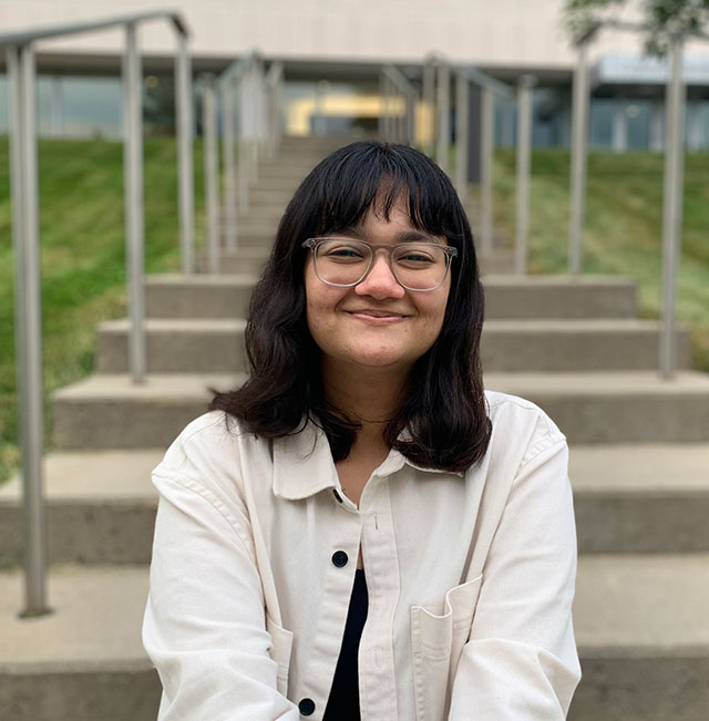 photo of Anannya Rawat '26 smiling while sitting on a staircase