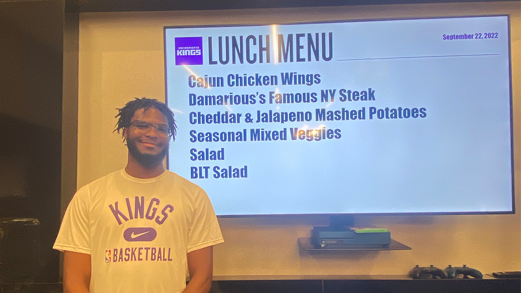 Borden pictured in front of his curated lunch menu prepared for the basketball team