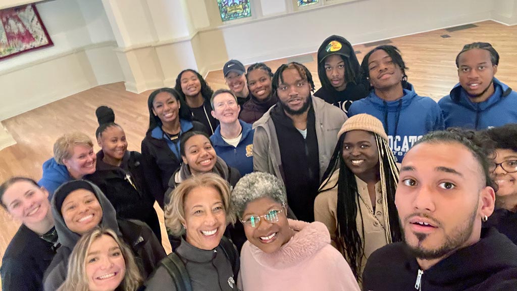 a group of JWU Charlotte students pauses to take a selfie while on a PBI experience field trip