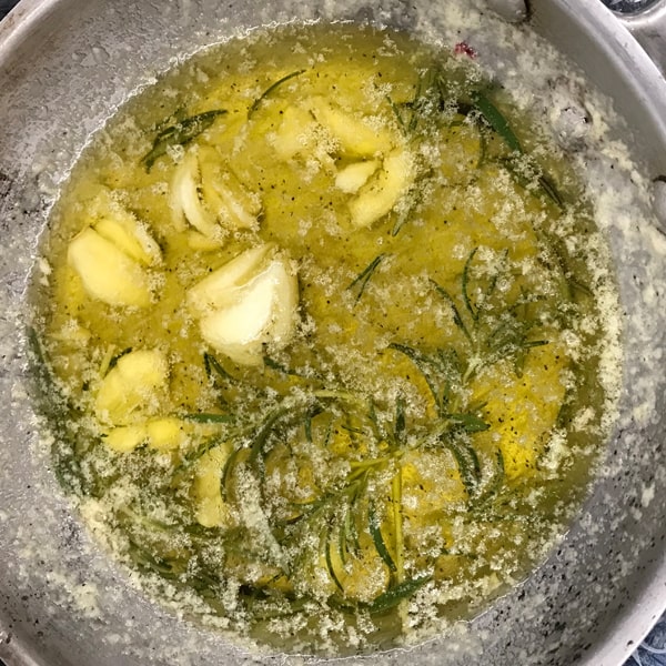 Brown butter sauce with garlic and herbs on the stove top.