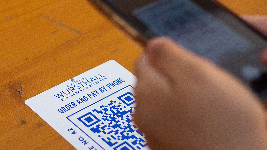 A person using their phone to scan a QR code