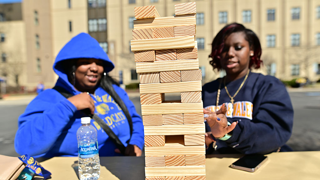 Two students playing Jenga