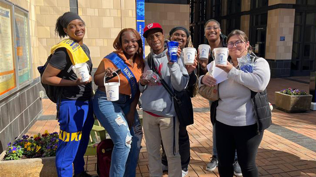 Students holding their sundaes from the One Ton Sundae event at JWU Charlotte