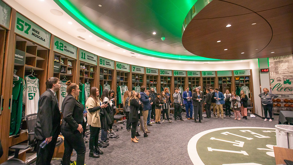 Students standing in the Boston Celtics locker room