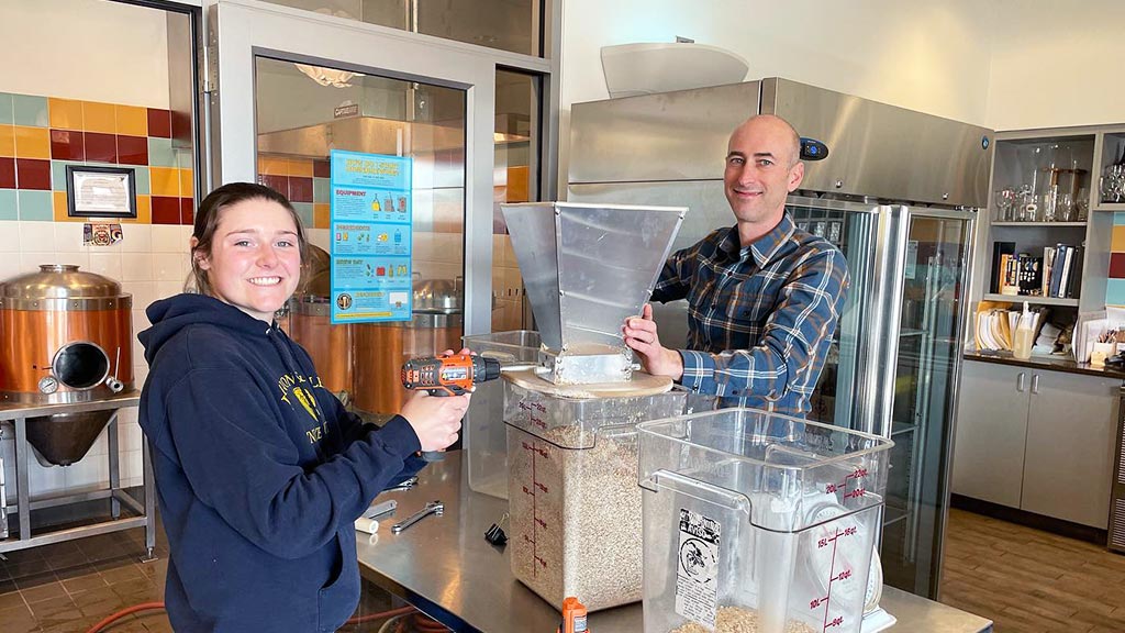 two JWU students and scholarship recipients are pictured brewing ale in a culinary lab