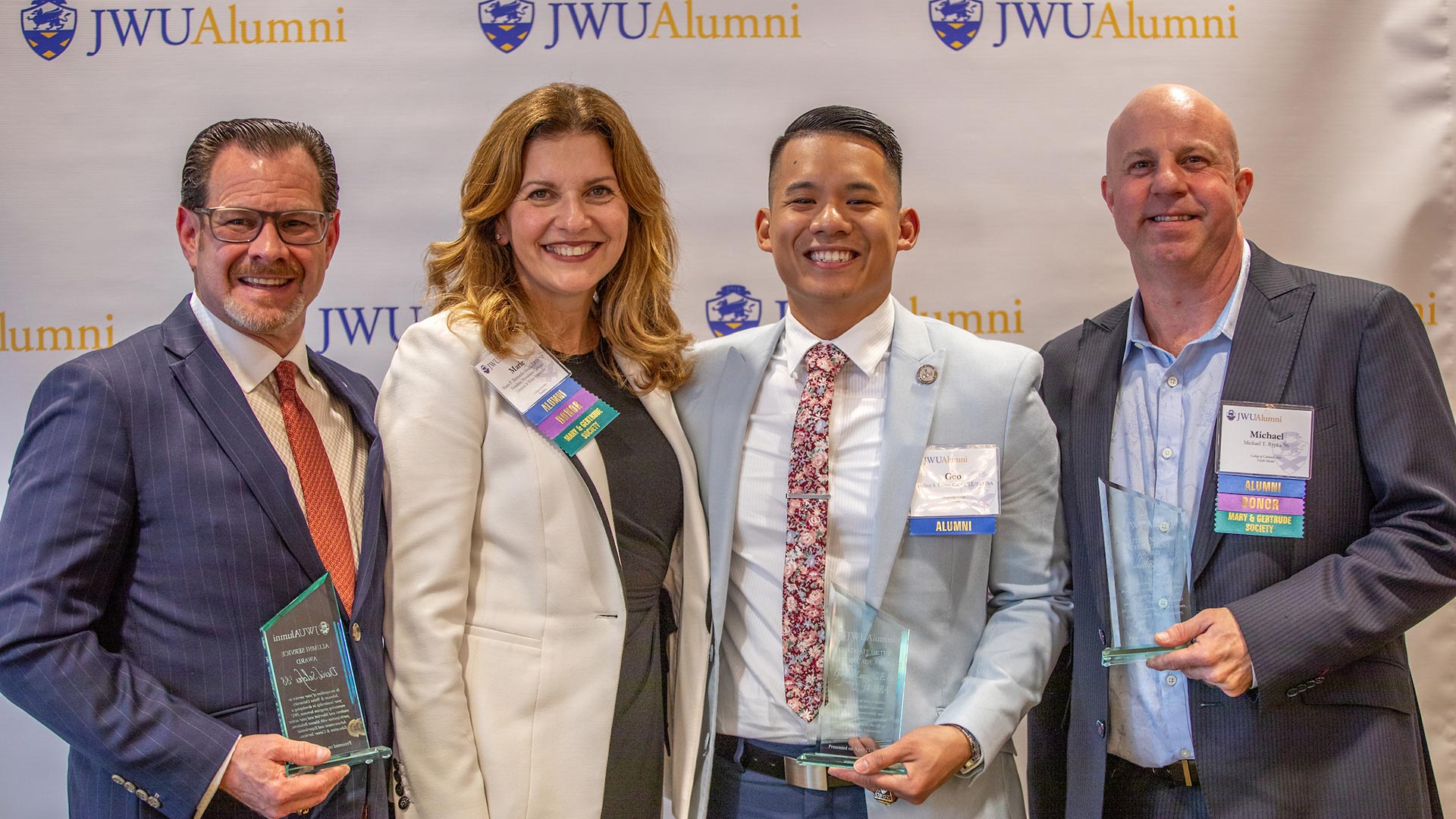 a photo of David Salcfas '88; JWU Providence Campus President Marie Bernardo-Sousa L.P.D. '92; Geo Lanez, C.E.C. '12, '14 MBA; and Michael Rypka '96