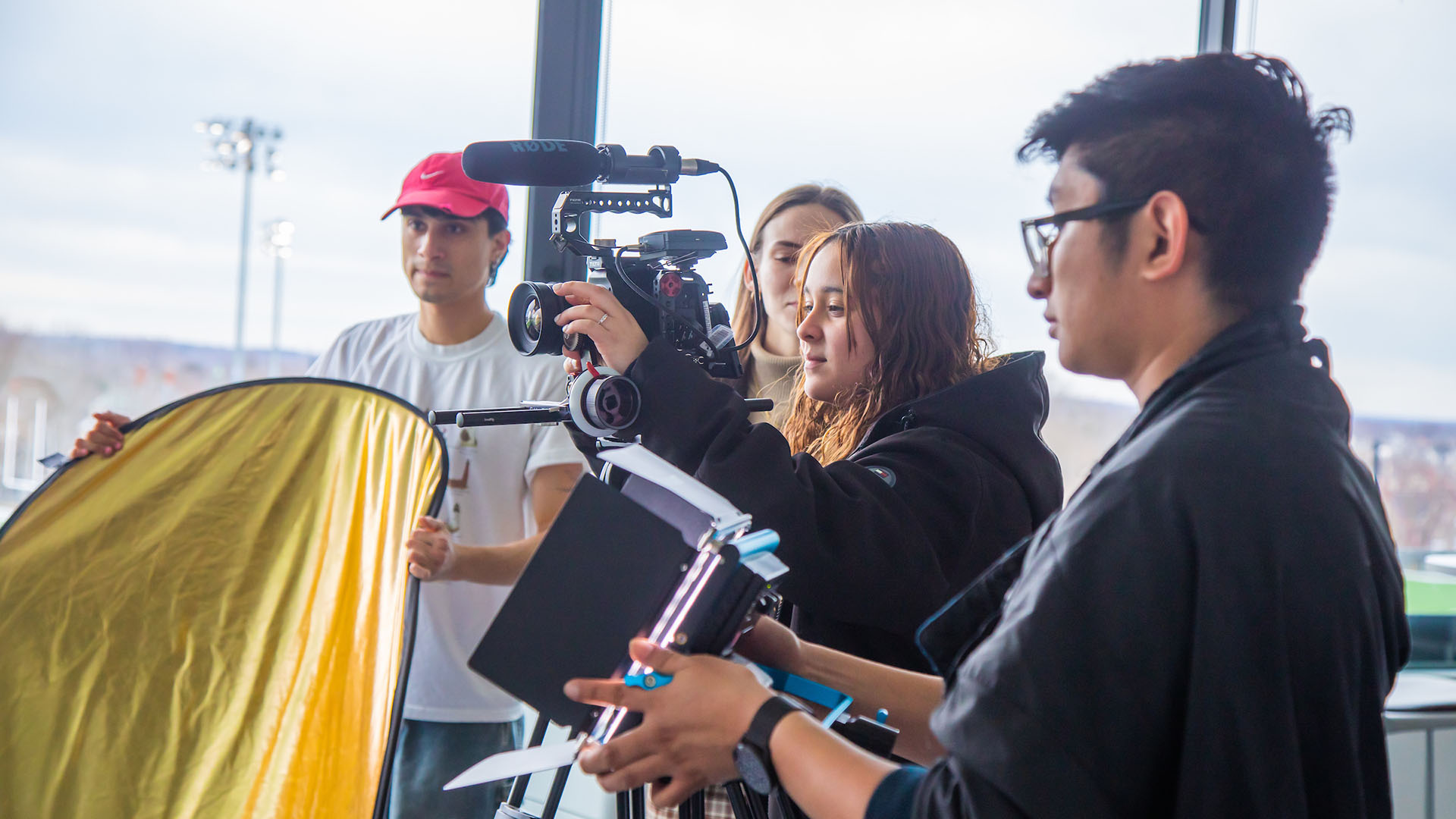 Students with a camera, light, and reflector