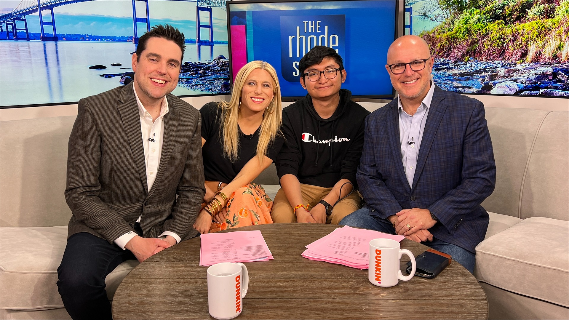 Aaron Aguilar sitting with staff of the rhode show