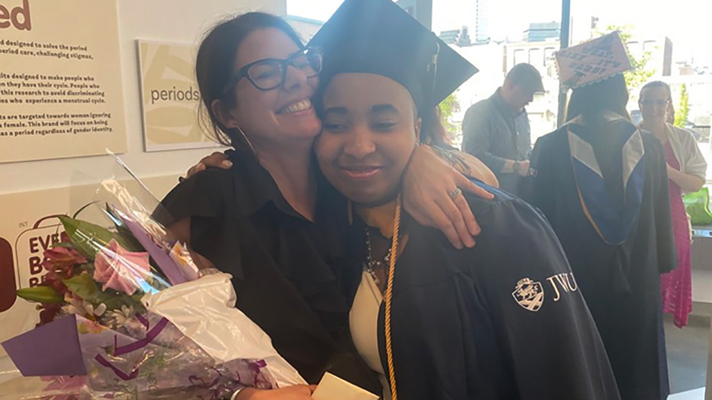 Professor Deanna Marzocchi hugging student Leah Ward '23 on Commencement day