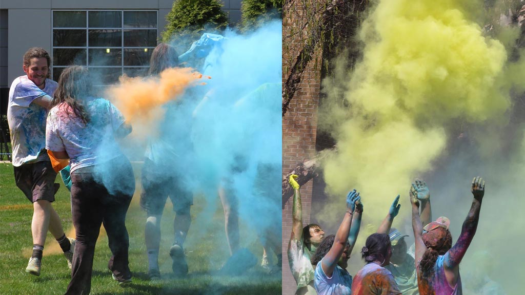group of students using yellow and blue chalk at Holi