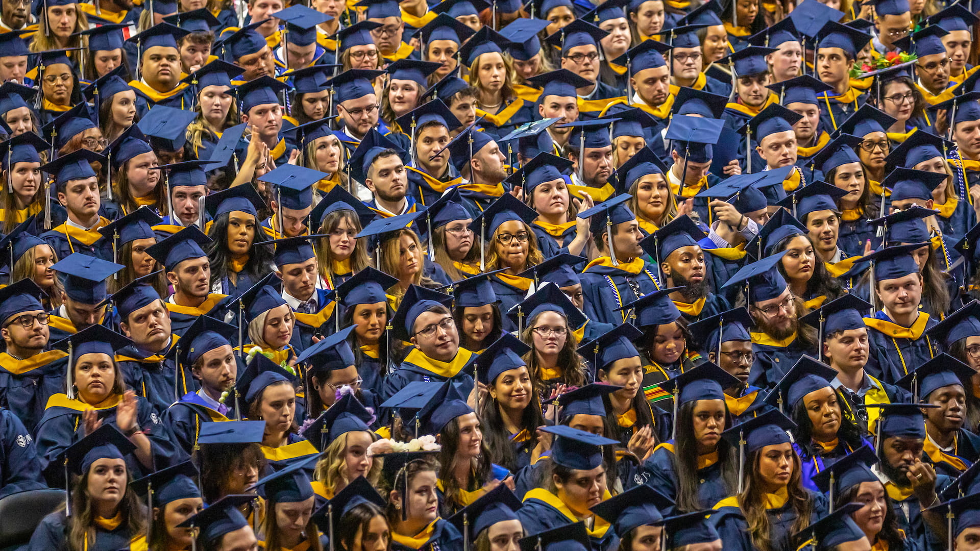 Tight closeup of a crowded sea of faces at the undergraduate Commencement ceremony.