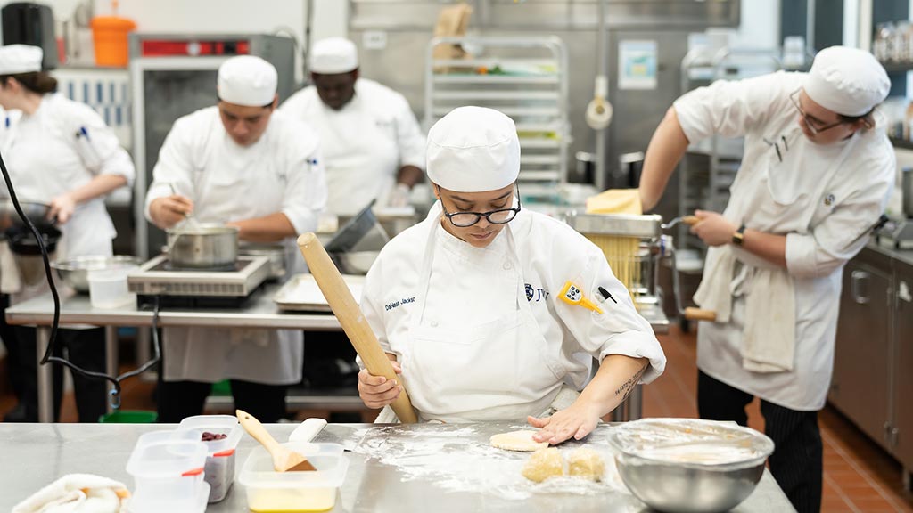 photo of students in a JWU Charlotte culinary lab developing restaurant-ready skills