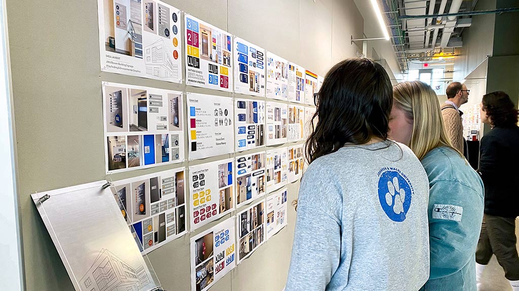 JWU students look over design options for new wayfinding at the John J. Bowen Center for Science and Innovation